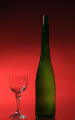 bottle of white wine on red background