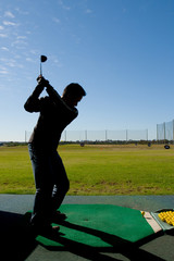 Man at golf driving range