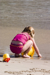 Young girl playing on the beach 