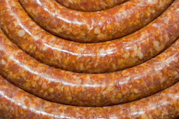 Top view of fresh, curved sausage pieces