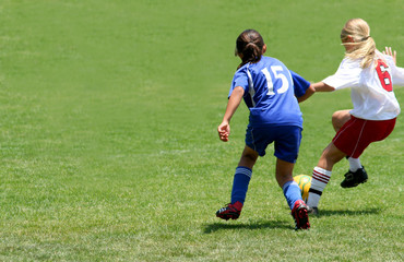 Girls playing soccer in a match