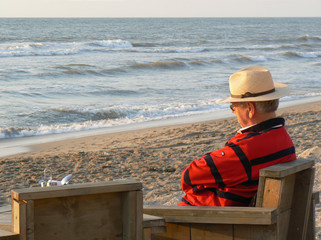 senior  relaxing while enjoying ocean view 