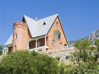 Stone cottage in mountains on a background of the dark blue sky