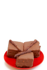 Two chocolate mini cakes on red plate, shot on white 