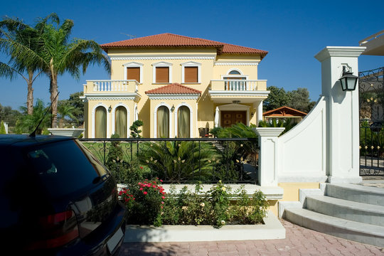 Luxury home and a car in the front of the house