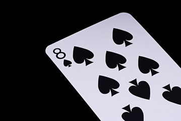 A poker card slanted view over black background