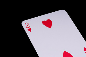 A poker card slanted view over black background