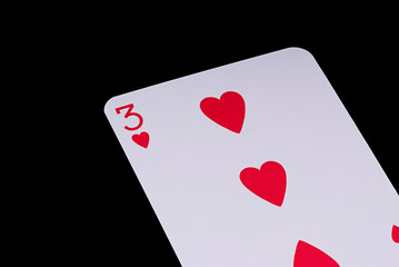 A poker card slanted view over black background