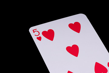 A poker card slanted view over black background