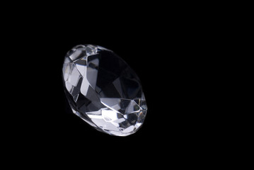 Close up of a cut diamond on black background