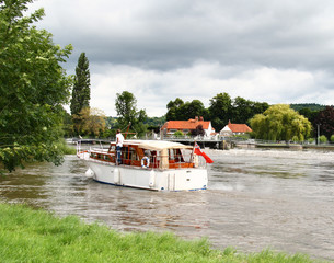 Naklejka premium Pleasure Boat on the River Thames with a Man Standng on the deck