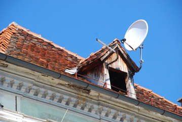 Old roof with dormer and satellite dish
