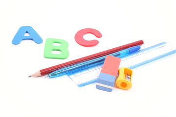 abc and some school supplies  isolated on white
