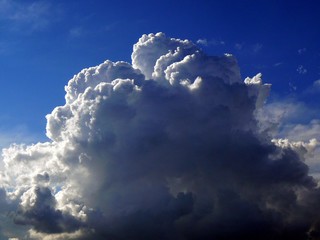 Fluffy White Cumulus Cloud Against Deep Blue Sky