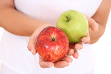 two apples red and green in hands on white