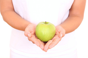 green apple in hands on white