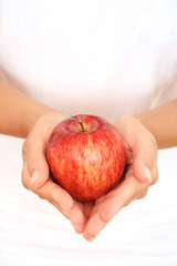 red apple in hands on white