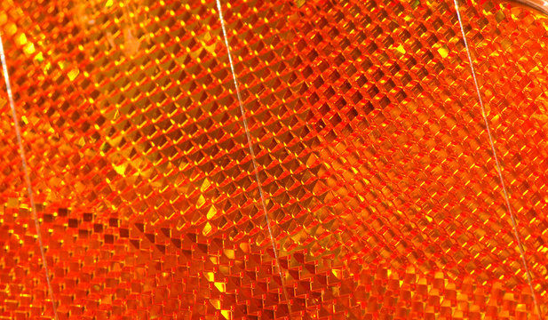Macro view of the orange reflector on a car