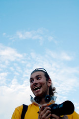 Young photographer with camera, positive, sky, space.