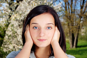 Portrait of a brunette nice girl in a park.