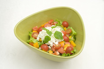 Fresh salad with cotage cheese in green bowl