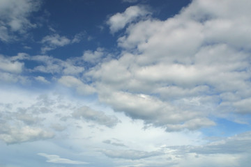 Blue sky and fluffy white clouds background.