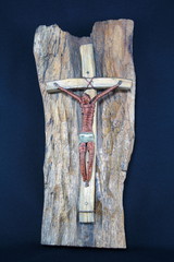 Brass and wooden crucifix on wood and black background