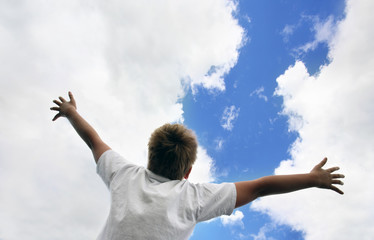 Boy with the open hands to the sky
