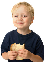 Little boy showing satisfaction while eating a sandwich