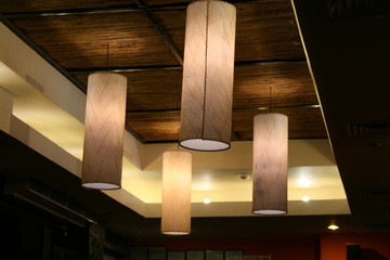 group of native lampshades attached to a ceiling