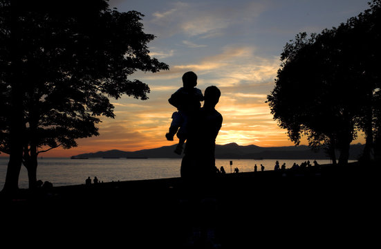 father and sun silhouette shot at sunset