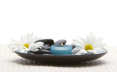 Massage stones and daisies