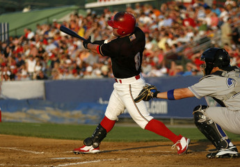baseball hitter swinging at a pitch