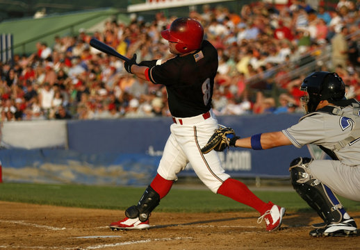 baseball hitter swinging at a pitch