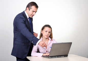  A male colleague offering a suggestion to a female coworker.