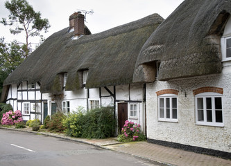 Row of Whitewashed and Timber Framed Thatched Village Cottages