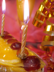 cake and golden candles on red background