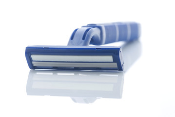 Blue plastic razor with reflection isolated on white. 