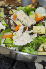 chicken stir fry white meat with vegetables on the stove