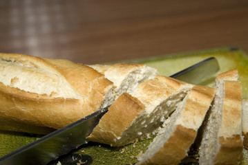 baquette on a breadboard with a knife