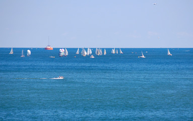 Racing sailboats and motorboat on a Great Lake