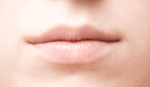 Woman mouth closeup. Soft colors.