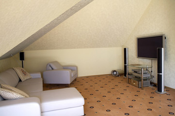 Armchairs, a sofa and a home theater in a modern cottage