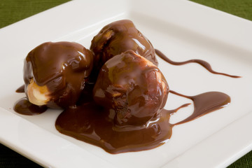 profiteroles with hot chocolate on withe platter