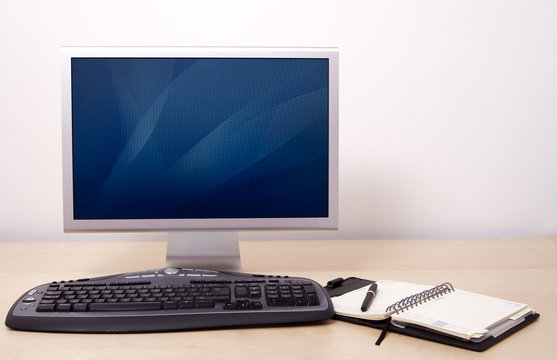 Computer In Office With Calendar And Pen. Switch On