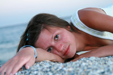 Young beautiful woman  lying on the beach