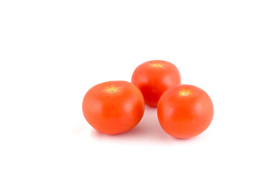 3 red tomatoes on a white background