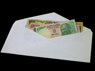 Indian currency in an open envelope