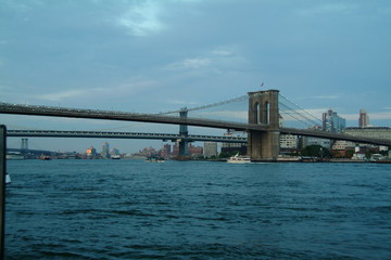 Tour Boat on the east river under the Brooklyn bridge