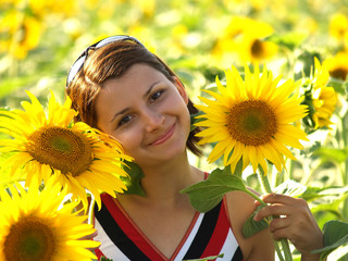 Girl posing in a field with sunflowers
